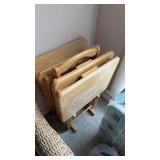 Set a four folding TV trays, on the stand