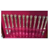 12 sterling silver handled dinner knives, in the