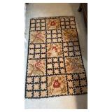 Vintage hooked rug, with large wear spots in the