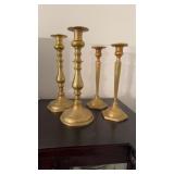 Two pair of antique cast brass candlesticks, one