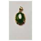 18 K & green jade pendant , oval stone , 1 inch