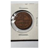 This antique token features a crest and shield