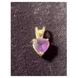 Small gold pendant with a heart shaped cut,