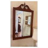 E A Clore cherry framed wall mirror with a finial