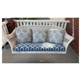 White wicker porch swing, with blue and white