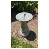 Concrete base with bronze sundial on top, that