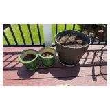 Three flowerpots, two matching green ones, one