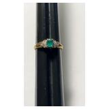 1 marked 18 K gold ring with center round,