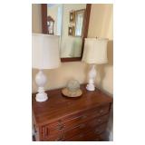 Two matching white, ceramic table lamps, with a