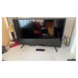 32 inch Roku flatscreen TV, with the remote