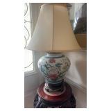 Vintage porcelain lamp on a carved wood base,