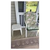 White hard plastic patio chair with a rose