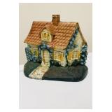 Vintage cast-iron cottage doorstop with original