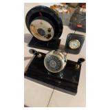 Two thermometers, and one small desk clock, one