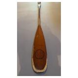 Antique canoe, paddle with a KC painted logo on