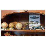 Top shelf with two baseballs, one softball, one