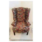 Vintage wingback chair with a muted, pink floral,
