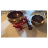 2 Tibetan, brass singing bowls, one is a red and