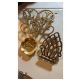 Two brass trivets and a brass molded horse,