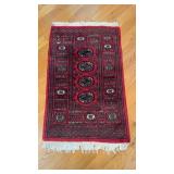 Small antique Persian carpet, with a red design,