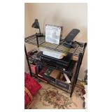 Three leveled, metal shelf unit, with the