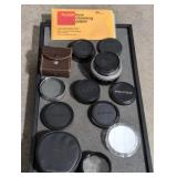Lot of camera lens covers, light meter, etc