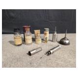 3 oil tins and 4 vintage bottles