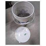 Five gallon pail half full of 2 1/2' finish nails