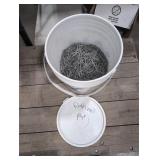 Five gallon pail half full of 1 3/4' finish nails