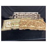 2 vintage table runners with damage to them and