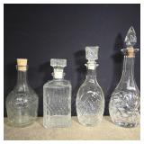 4 glass decanters with tops 13' and 10'