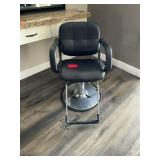 Black salon chair with metal base