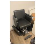 Black leather salon chair with metal base