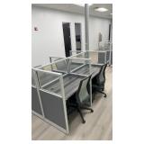 Four-person open-plan cubicle cluster featuring