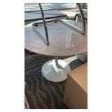 Round dining table featuring a polished white and