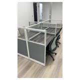 Four-person open-plan cubicle cluster featuring