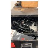 Black 4-drawer metal filing cabinet with contents.
