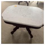 MARBLE TOP COFFEE TABLE W/ CARVED BASE & CASTERS