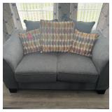 Gray Loveseat With Patterned Accent Pillows