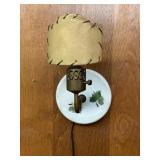 Vintage wall sconce featuring a painted ceramic