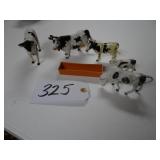 Assorted toy cows and trough