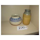 2 pottery jars, signed not legible