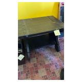 Rustic-style coffee table featuring a dark wood..