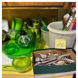 Assorted green kitchen utensils, silverware, an..