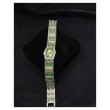 Silvertone wristwatch with green accents