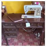 Vintage Singer sewing machine is installed in a..