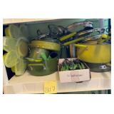 Assorted green pots and pans and silverware