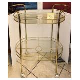 Vintage brass and glass bar cart in the Hollywo..