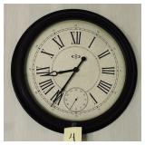 Black framed round wall clock with cream dial a..
