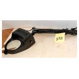 black task lamp with a 3.5-inch magnifying lens..